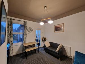 a living room with a couch and a table at Nice Living Serviced Accommodations 11 in Coventry
