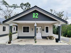 a building with a sign on top of it at D'Batu Hampar Homestay Chalok in Kampong Batu Hampar