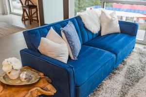 a blue couch with pillows on a table at 5M412- Sophisticated 1BR Condo in Nashville