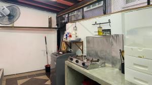 a kitchen with a stove and a counter top at 27Homestay - Landed House, Complete Facilities with 3Br & WiFi in Cheras