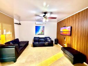 a living room with a couch and a ceiling fan at CocoHouse in Horconcitos