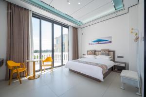 XiashanMeizhou Island Zhengxinju Homestay的一间卧室，配有一张床、一张桌子和几把椅子