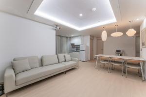 a living room with a couch and a table at Marant Residence Hotel Busan Station in Busan +18 photos