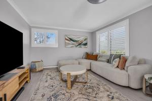 a living room with a couch and a tv at LandSea Mirador - 4 Bedroom in Mirador