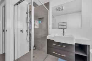 a white bathroom with a sink and a shower at LandSea Mirador - 4 Bedroom in Mirador +16 photos