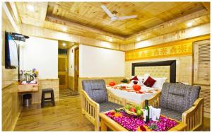 A television and/or entertainment centre at MANALI HOTEL H A R M O N I near river and temple