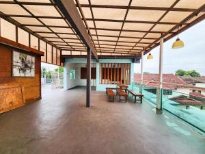 a room with a balcony with a table and benches at Kempas -- 32 Pax SemiD, Near Paradigm Mall JB in Johor Bahru