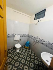 a bathroom with a sink and a toilet at Shri Ganesh Residency And Restaurant in Dharmastala