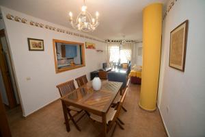 a dining room and living room with a table and chairs at Apartamento Zahara in Zahara de los Atunes