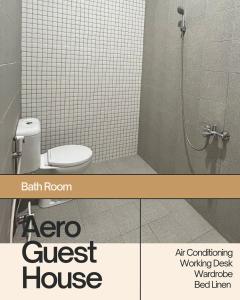 a bathroom with a shower and a toilet and a shower stall at Aero Guest House in Timuran +14 photos