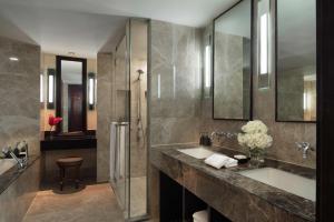 a bathroom with a sink and a shower at Anantara Riverside Bangkok Resort in Bangkok
