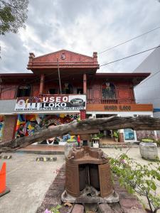 a building with a sign in front of it at Agoo Tourist Cabin in Agoo