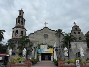 a church with two crosses and two towers at Agoo Tourist Cabin in Agoo
