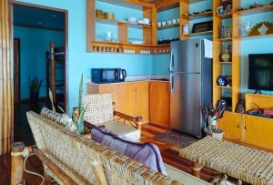 a living room with couches and a refrigerator at Casa Nena Hotel & Resort Iloilo by RedDoorz in Iloilo City