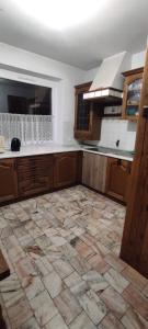a kitchen with a tile floor and a kitchen with a ceiling at Adam room 1 in Wrocław +15 photos