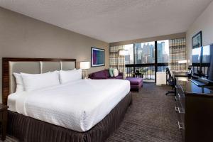 a hotel room with a large bed and a television at Crowne Plaza Atlanta Midtown, an IHG Hotel in Atlanta