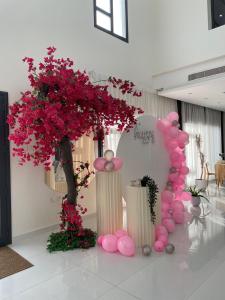 a bunch of pink balloons and a tree in a room at Lammah chalet in Āsam +42 photos