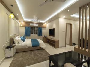 a bedroom with a bed and a table and a television at Mountail Eco Resort in Netarhāt