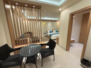a room with a bed and a table and chairs at Mountail Eco Resort in Netarhāt
