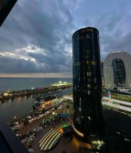 a view of a city with a tall building at Orbi City - "A" in Batumi