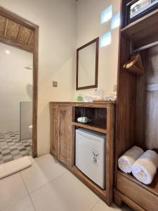 a bathroom with a sink and a mirror at Blue Harbor Beachfront Villas & Resto in Nusa Penida