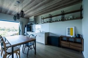 a kitchen and dining room with a table and chairs at Seaside Villa N Plus in Mitsugoe