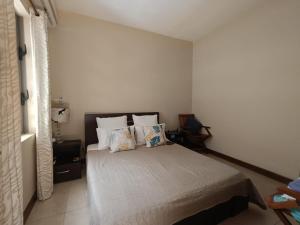 a bedroom with a bed with pillows on it at Villa Athena at Grand Baie with private pool in Grand Baie +15 photos