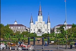 a horse drawn carriage in front of a building at La Galerie French Quarter Hotel in New Orleans