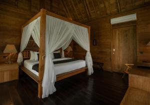 a bedroom with two beds in a wooden cabin at Natajiwa Village in Seminyak