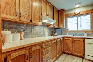 a kitchen with wooden cabinets and a sink at The Bend House in Bend +31 photos