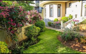 a house with a garden with flowers and plants at The Manor Hanthana in Kandy