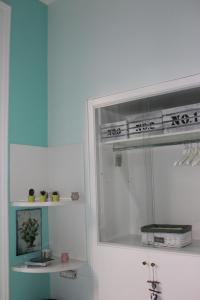 ein Badezimmer mit einem Spiegel, einem Regal und einem Waschbecken in der Unterkunft Viaggio a Napoli B&B in Neapel
