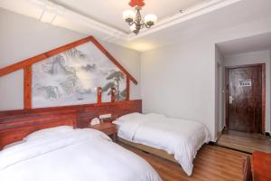 Krevet ili kreveti u jedinici u objektu 张家界如晤山居人文客栈