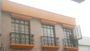 a building with windows and balconies on it at Hotel Colonial in Pereira