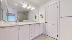 a white bathroom with a sink and a mirror at Connected Comfort - 7BR Family Retreat - Near Pearson Airport & Toronto Downtown in Brampton +79 photos