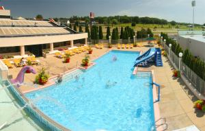 a large swimming pool in a hotel with people in it at Grand Marquis Waterpark Hotel & Suites in Wisconsin Dells