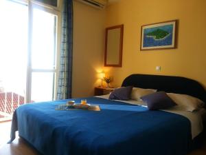 a bedroom with a blue bed with a tray on it at Dubrovnik Residence Nodilo in Dubrovnik