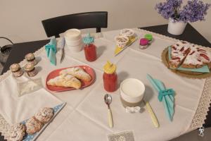a table with a table cloth with food on it at B&B Mar del Plata in Porto Recanati
