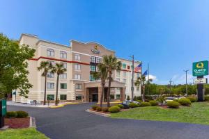 a rendering of a hotel with palm trees in a parking lot at Quality Inn & Suites North Myrtle Beach in Myrtle Beach