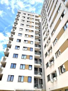 a tall white apartment building with balconies at Vitan Marvel in Bucharest