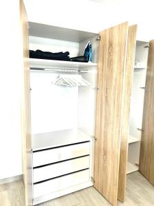 a closet with white drawers and a open door at Vitan Marvel in Bucharest