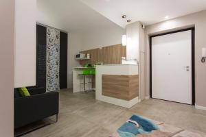 a living room with a large door leading to a kitchen at Frammenti in Matera