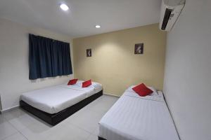 Postel nebo postele na pokoji v ubytování Hotel Inap Sri Gombak