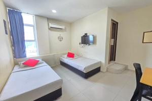 Postel nebo postele na pokoji v ubytování Hotel Inap Sri Gombak