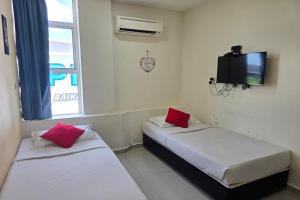 Postel nebo postele na pokoji v ubytování Hotel Inap Sri Gombak