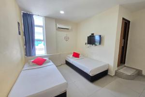 Postel nebo postele na pokoji v ubytování Hotel Inap Sri Gombak