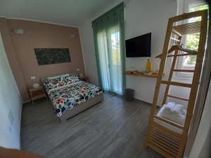 a small bedroom with a bed and a ladder at Stasonis in Quartu SantʼElena