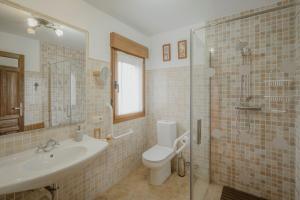 a bathroom with a toilet and a sink and a shower at La Cardeñuela in Burgos +19 photos