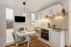 JesbergTiny House im Grünen的厨房配有白色橱柜、水槽和柜台。
