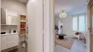 a kitchen with a sink and a table in a room at expat renting - Le Volta - Terrasse - Netflix in Toulouse +30 photos
